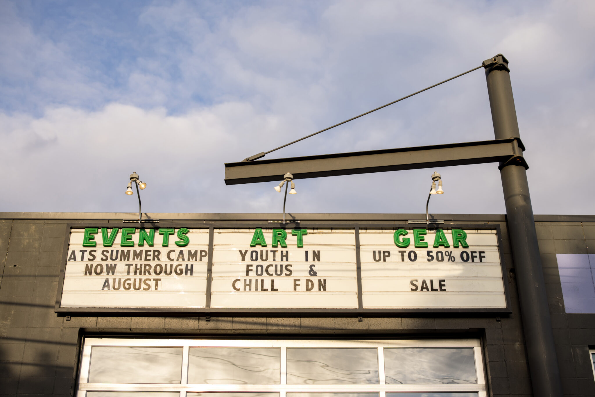 A large street sign advertising upcoming events