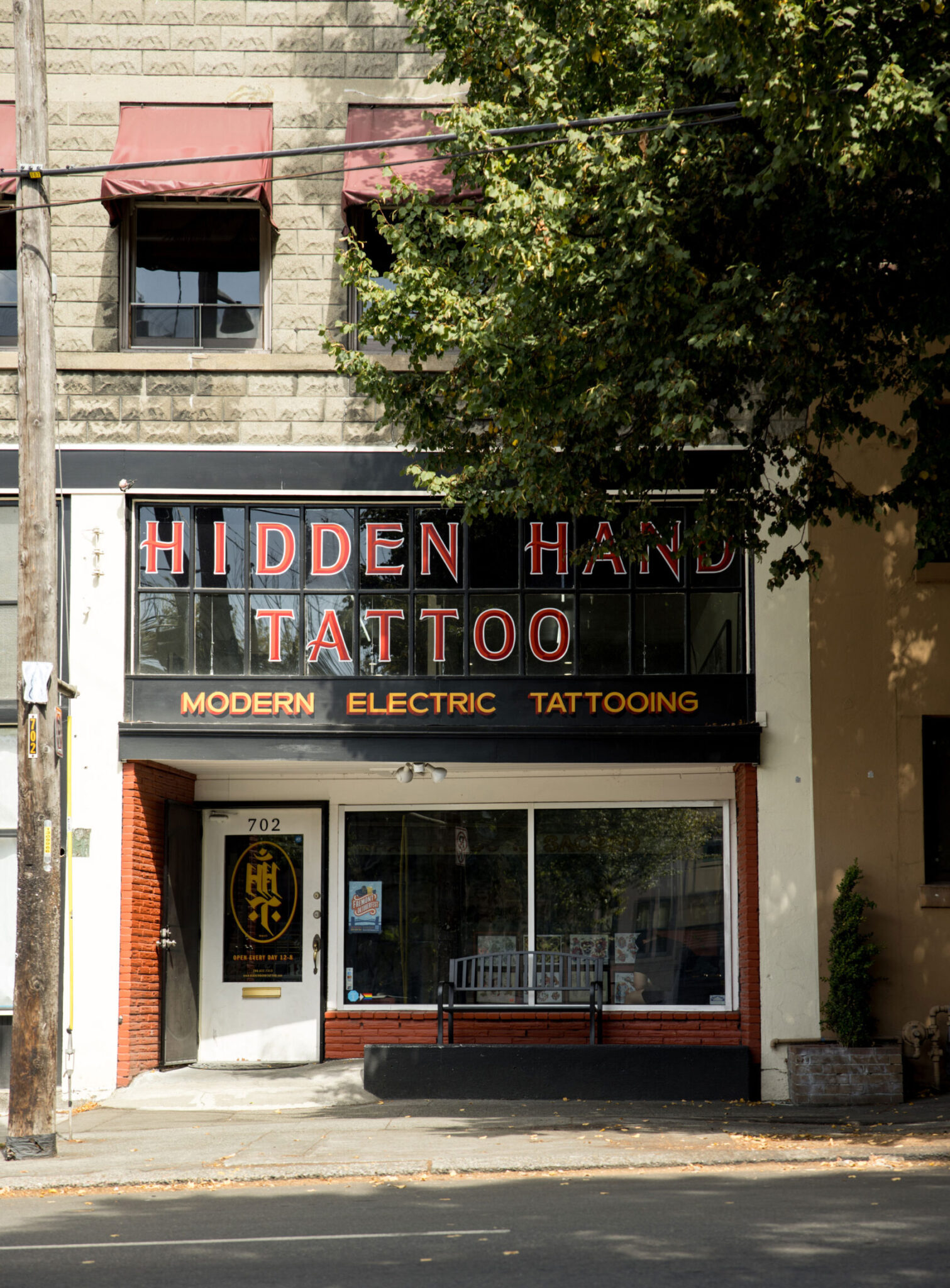 a store front for a tattoo parlor called hidden hand tattoo