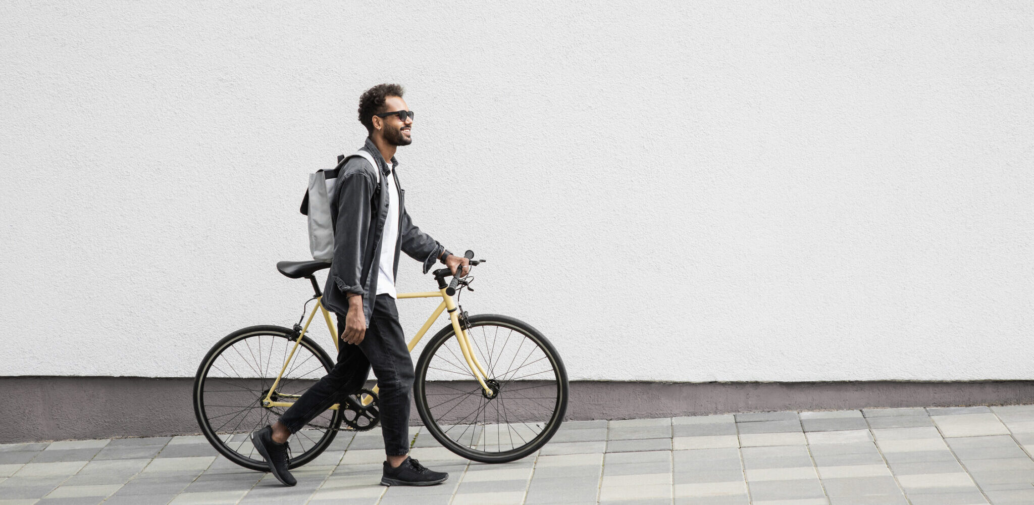 young man with bicycle in a city
