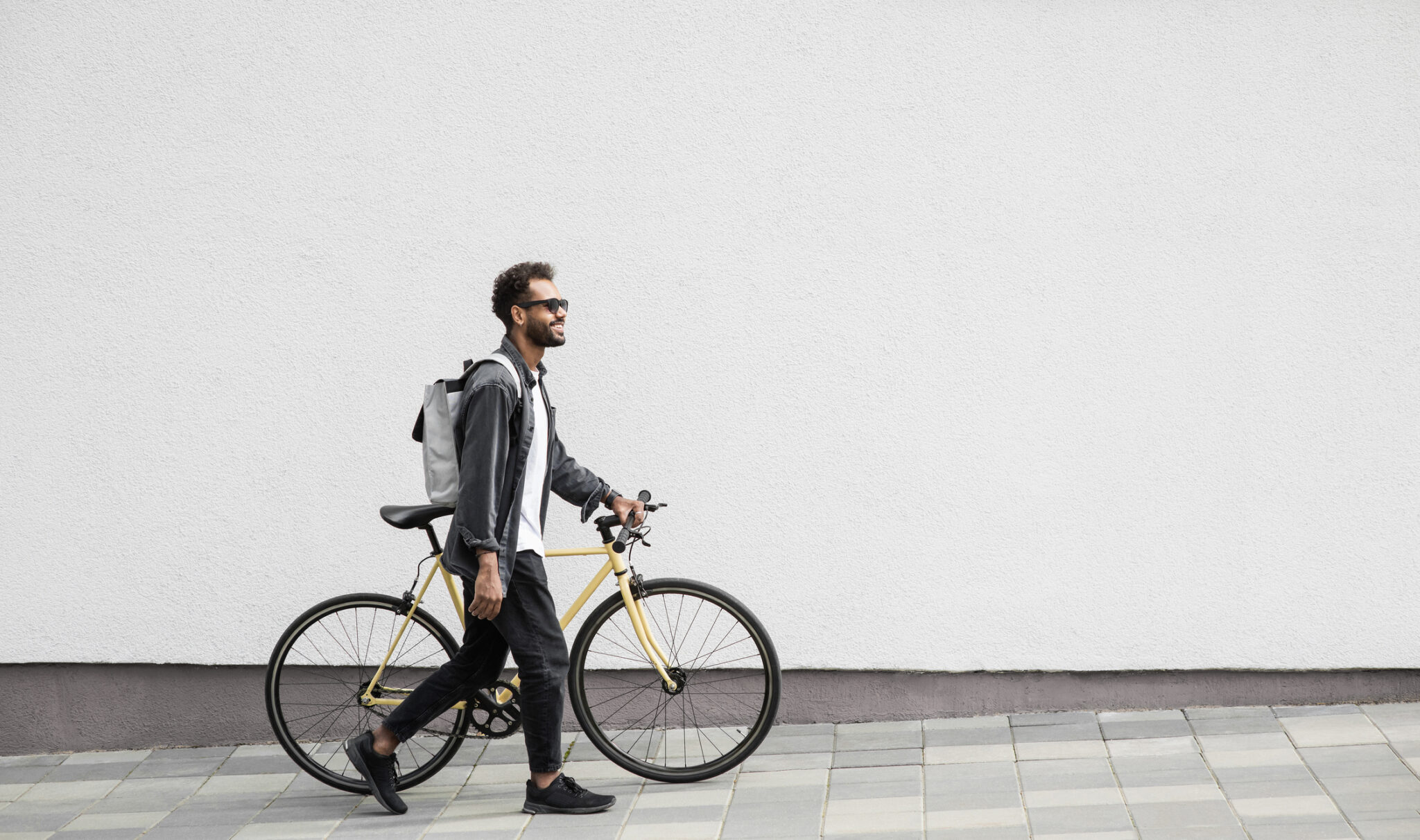 young man with bicycle in a city